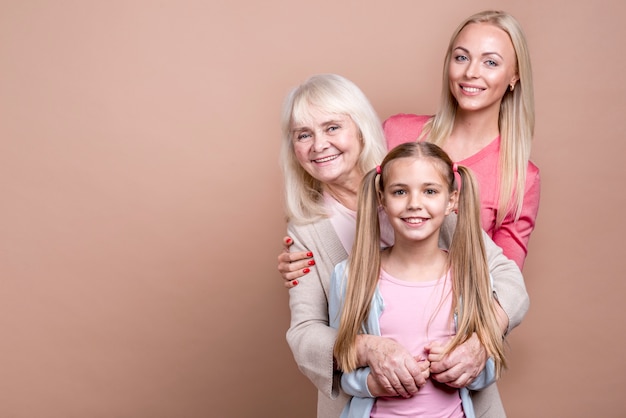 Free photo portrait of three generations of happy beautiful women and copy space