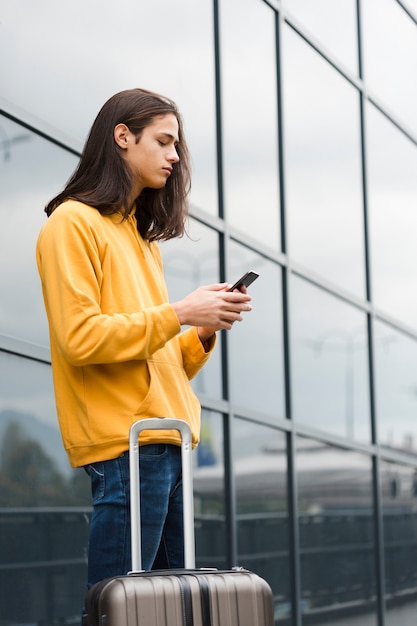 Portrait of traveler checking his phone