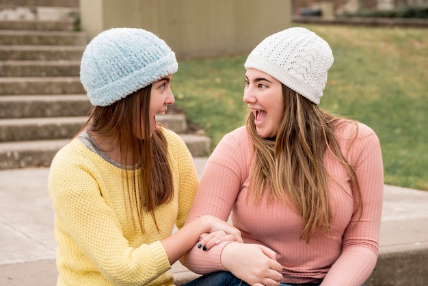 Portrait of two girls in urban environment having fun