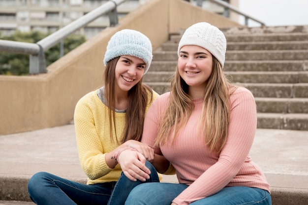 Free photo portrait of two girls in urban environment having fun