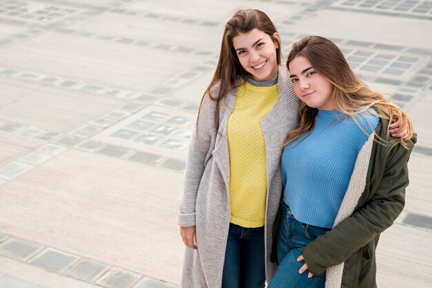 Portrait of two girls in urban environment having fun