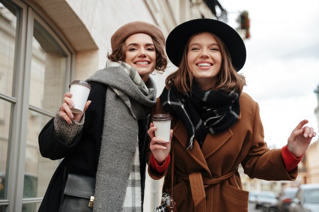 Portrait of two happy girls dressed in autumn clothes