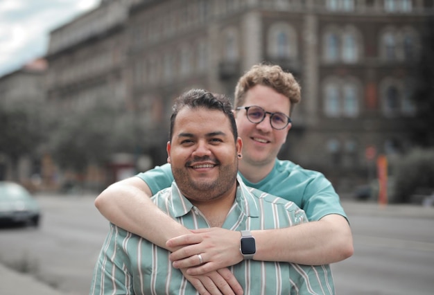 portrait of two men in the street hugging each other