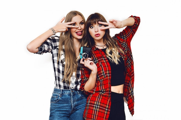 Free Photo portrait of two pretty women posing on white wall