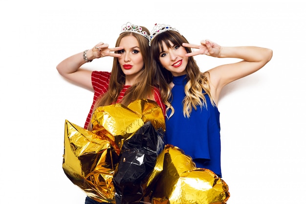 Free Photo portrait of two pretty women with bright party balloons