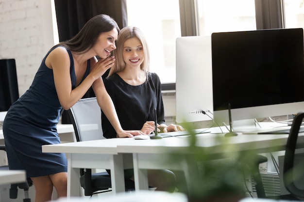 Free Photo portrait of two smiling business woman working in office