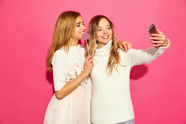 Free Photo portrait of two young stylish smiling blond women