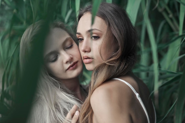 portrait of two young women under a tree