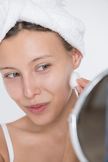 Free Photo portrait of white woman doing her daily skincare routine