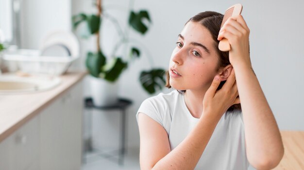 Portrait of woman arranging her hair