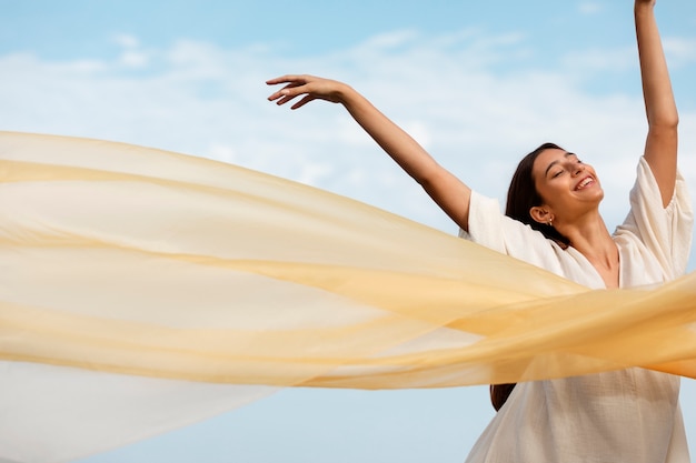 Portrait of woman at the beach posing with veil