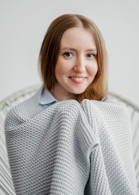 Free photo portrait woman covered with blanket