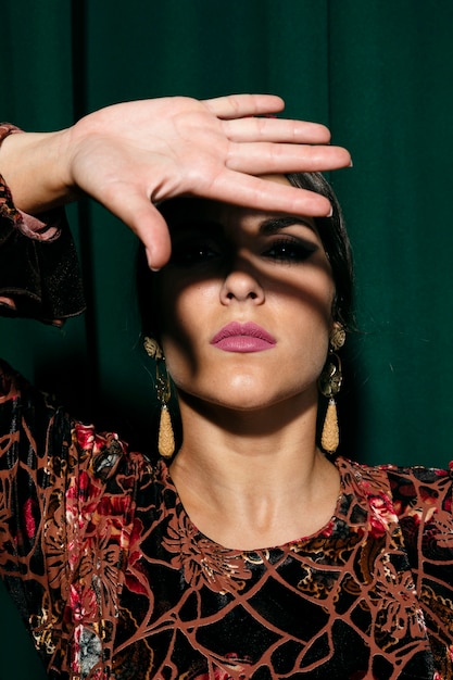 Free photo portrait woman covering face with hand