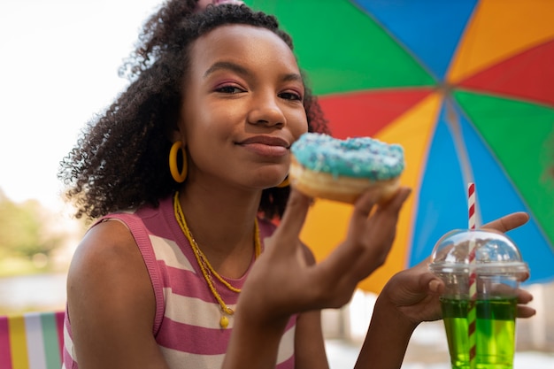 Portrait of woman eating donuts