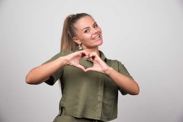 Portrait of woman giving heart to someone.