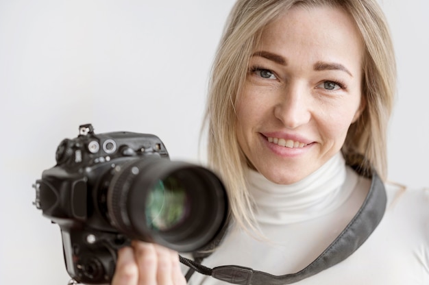 Portrait of woman holding a camera photo