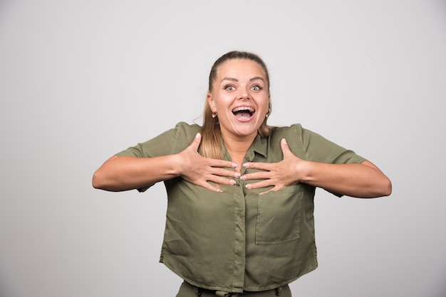 Portrait of woman holding her chest because of feeling happy.