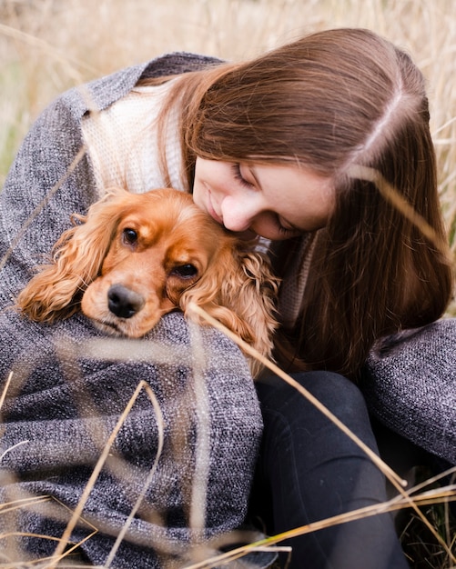 Free Photo portrait of woman holding her dog