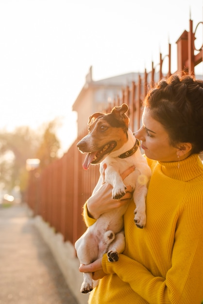 Portrait of woman holding her puppy