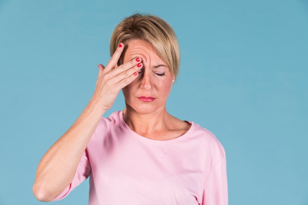 Portrait of a woman holding his head in pain