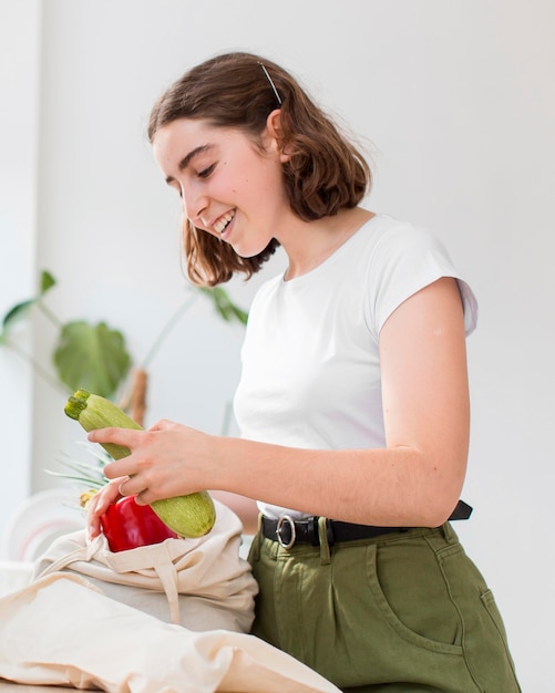 Portrait of woman holding organic vegetables