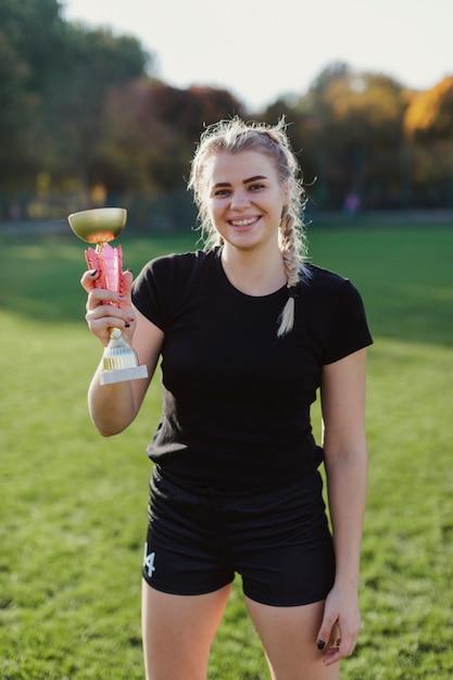 Portrait of woman holding a trophy