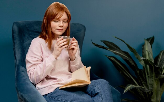 Portrait woman at home drinking coffee and reading