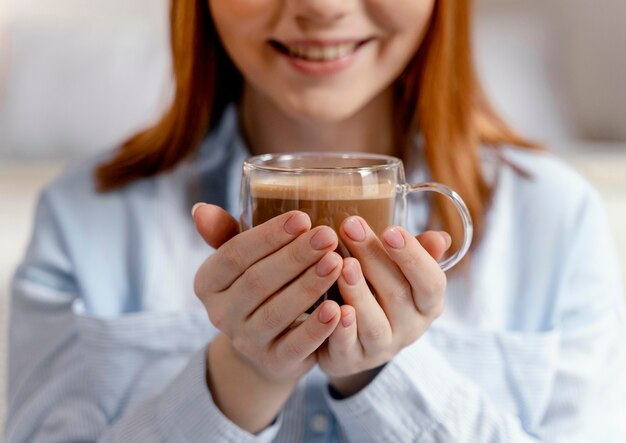 Portrait woman at home drinking coffee