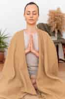 Free photo portrait woman meditating