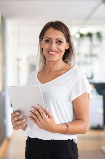 Portrait of woman at the office with tablet