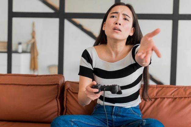 Portrait woman playing with joystick