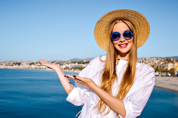 Portrait of woman posing near blue sea at French Cannes city