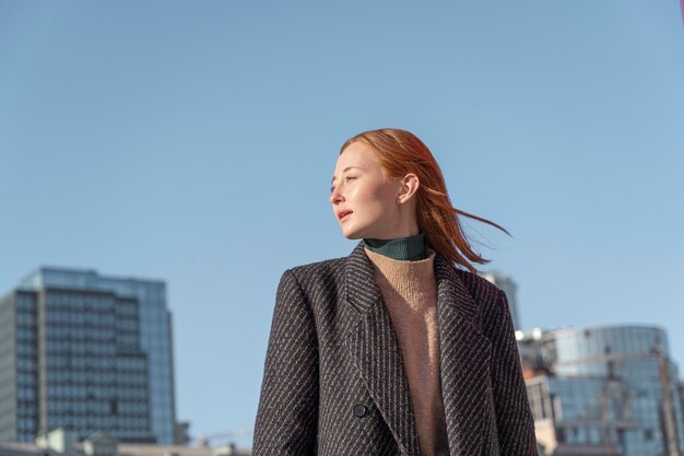 Portrait of woman posing outdoors against the sky