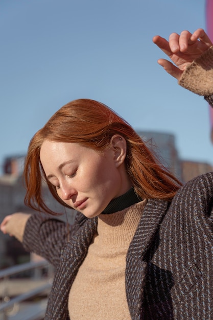 Portrait of woman posing outside against the sky