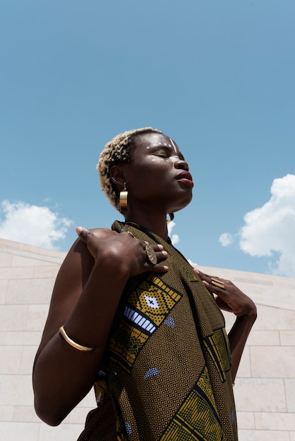 Free Photo portrait of woman posing in traditional african attire outdoors