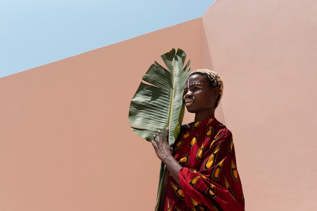 Free Photo portrait of woman posing in traditional african attire outdoors