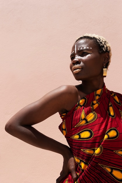 Portrait of woman posing in traditional african attire outdoors