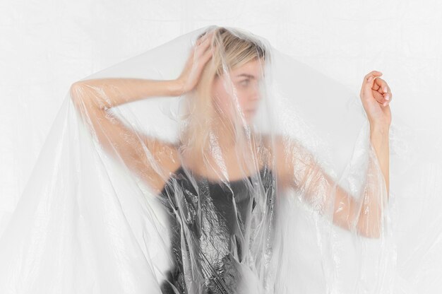 Portrait woman posing with plastic foil