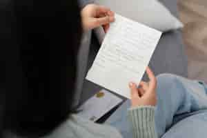 Free photo portrait woman reading letter close up