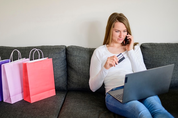 Free photo portrait of woman shopping online from home