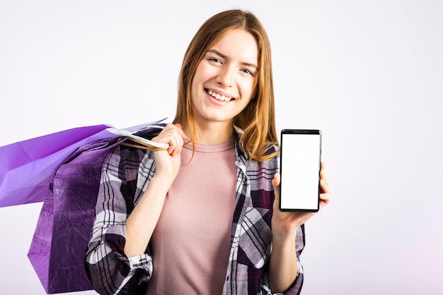 Free Photo portrait woman showing phone at the camera