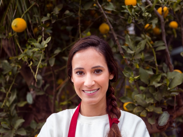 Portrait of woman standing in front of lemon tree