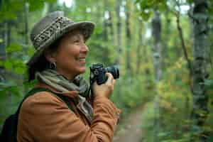 Free photo portrait of woman taking photo with device for world photography day