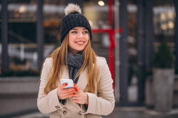 Portrait of woman talking on phone in the street