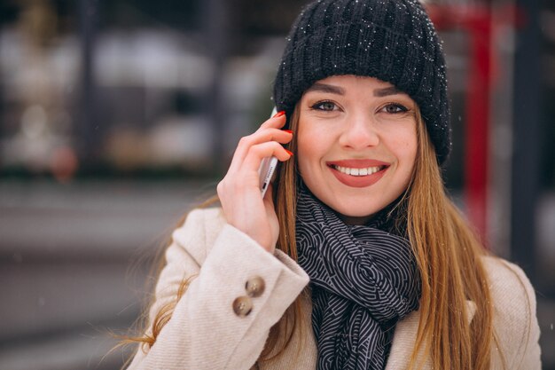 Portrait of woman talking on phone in the street