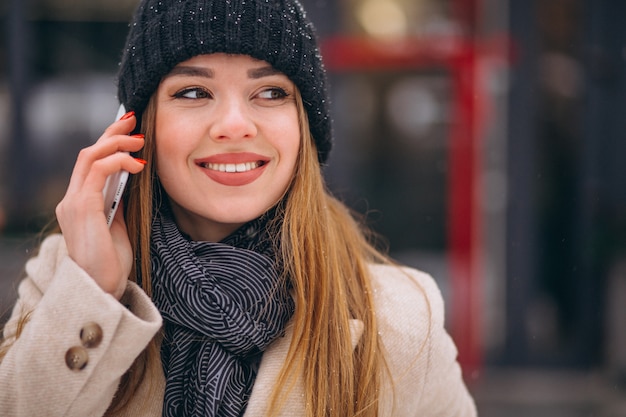 Portrait of woman talking on phone in the street