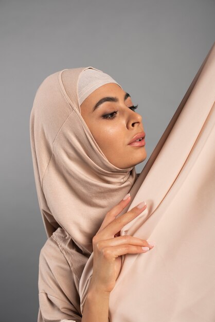 Portrait of woman wearing hijab isolated