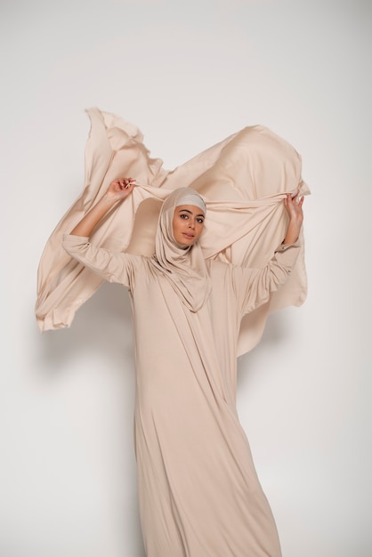 Portrait of woman wearing hijab isolated