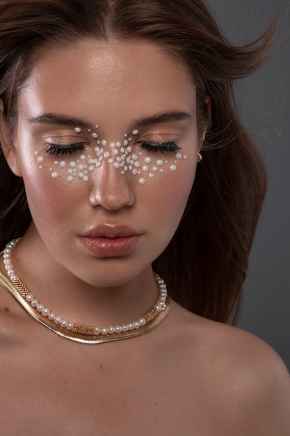 Free Photo portrait of woman wearing jewelry makeup