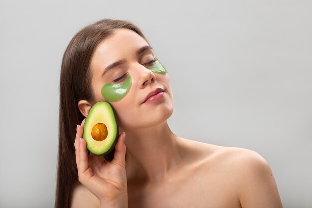 Portrait of woman with avocado eye-patches